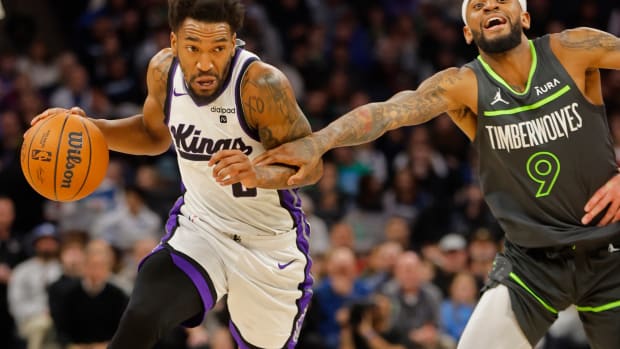 Mar 1, 2024; Minneapolis, Minnesota, USA; Sacramento Kings guard Malik Monk (0) works past Minnesota Timberwolves guard Nickeil Alexander-Walker (9) in the first quarter at Target Center. Mandatory Credit: Bruce Kluckhohn-USA TODAY Sports